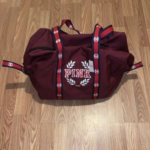 Pink burgundy duffel bag.